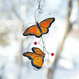 Window glass decoration in the shape of a colorful butterfly