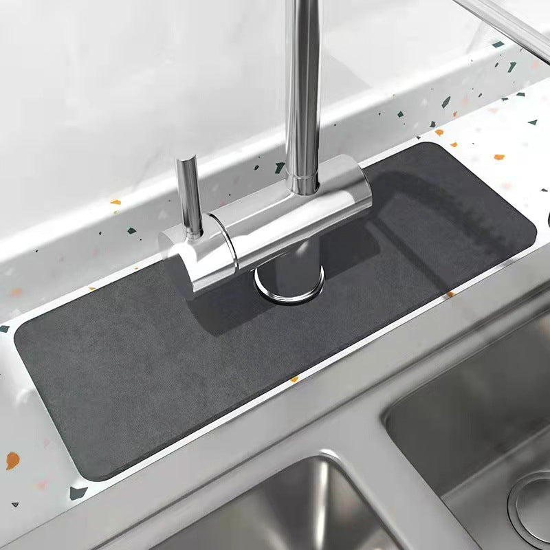 Absorbent faucet pad with diatomaceous earth