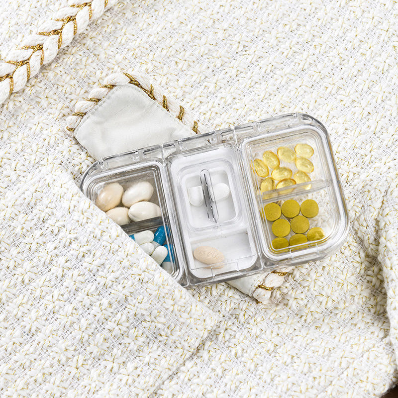 Pill box with a built-in cutter 